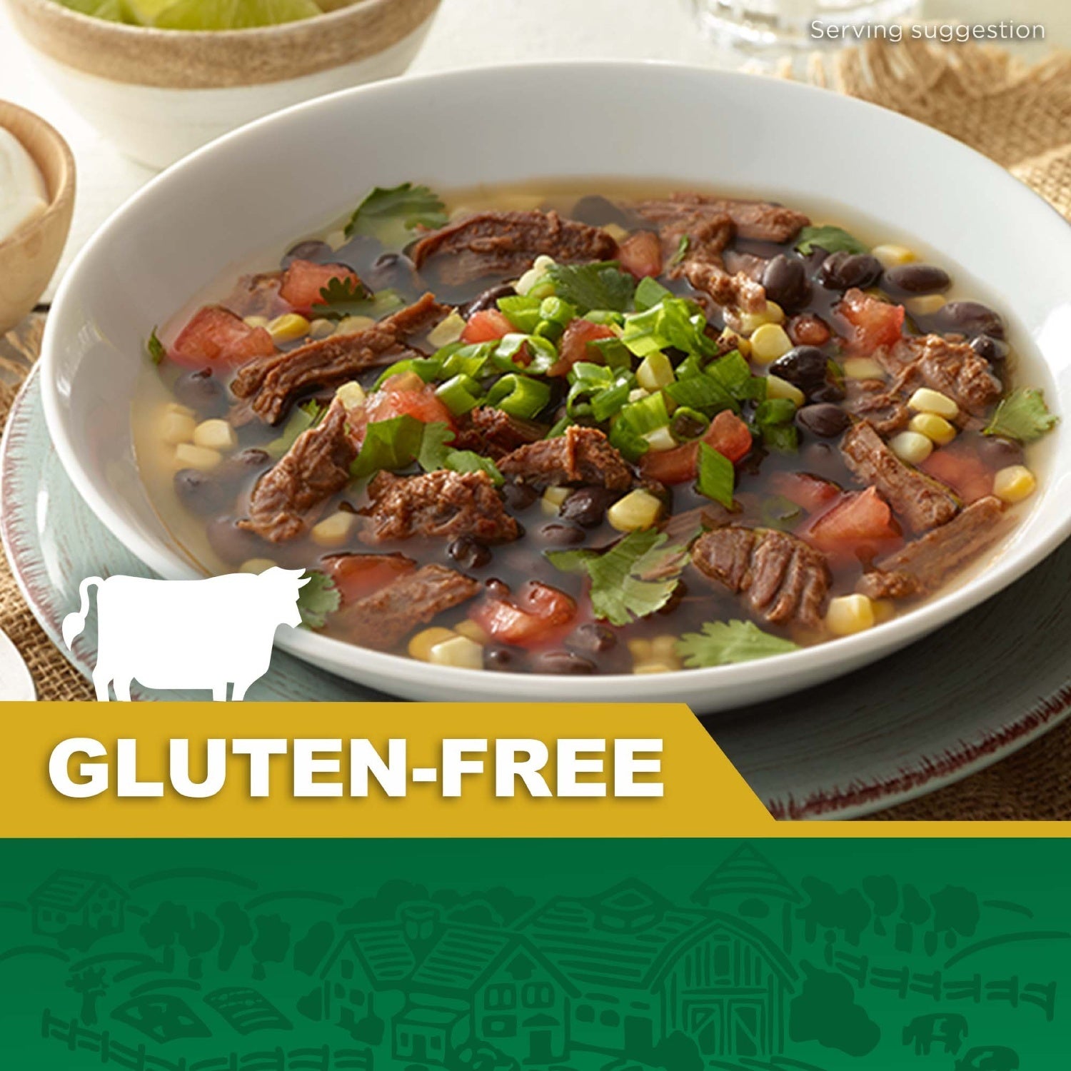 Bowl of gluten-free beef soup with shredded beef, black beans, corn, tomatoes, and fresh cilantro, with a gluten-free label and cow icon.