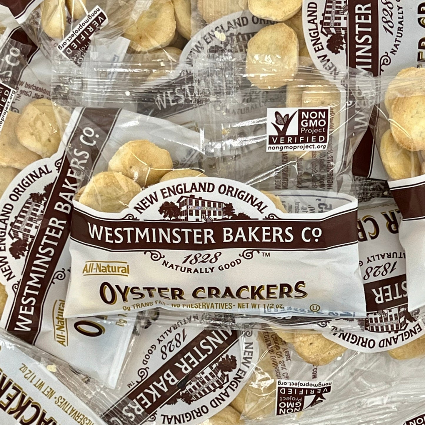 Several bags of Westminster Bakers Co. oyster crackers, labeled as all-natural and non-GMO verified.
