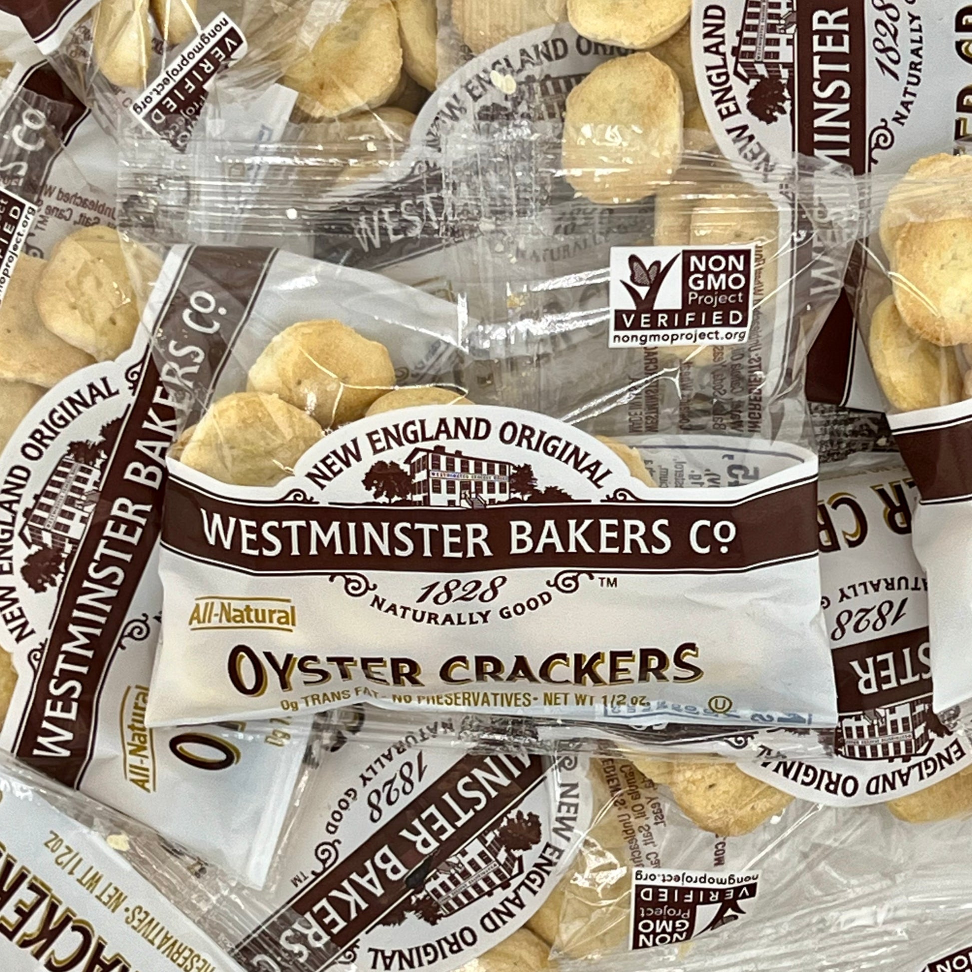 Several bags of Westminster Bakers Co. oyster crackers, labeled as all-natural and non-GMO verified.