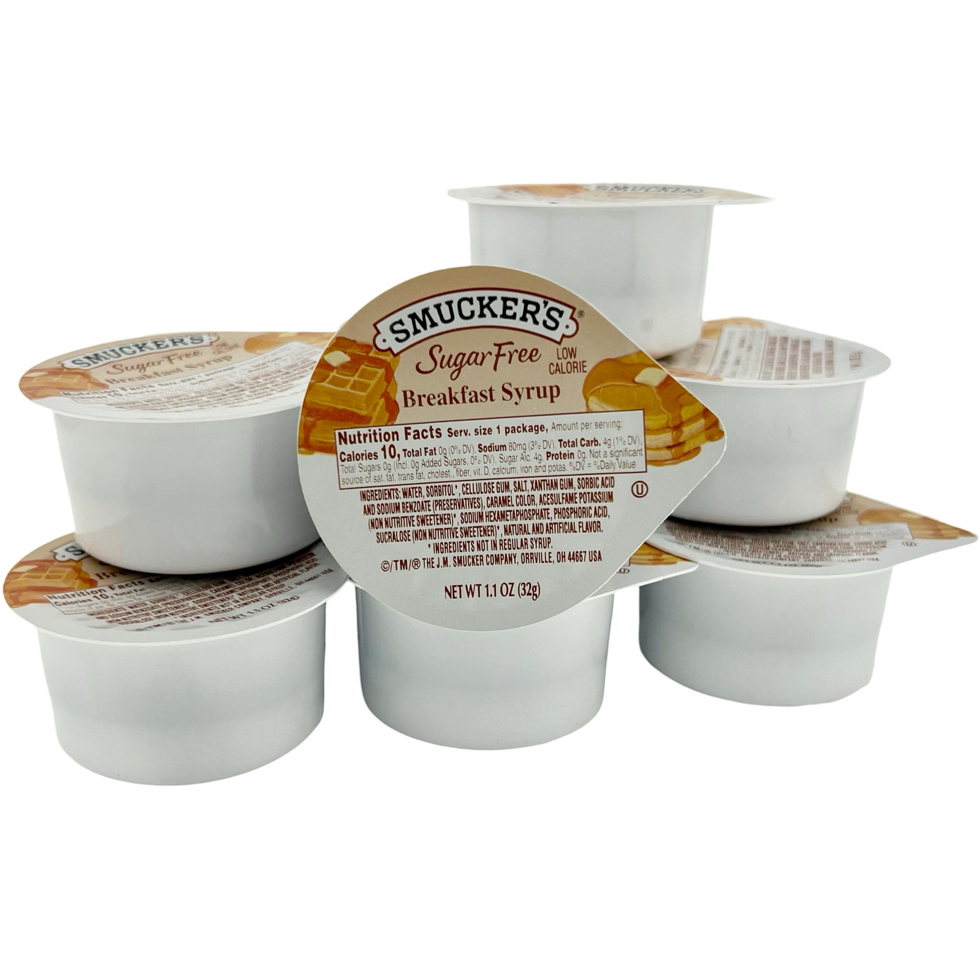 Stack of Smucker's sugar-free breakfast syrup cups, low calorie, 1.1 oz each, with nutrition facts and ingredients on the lid.
