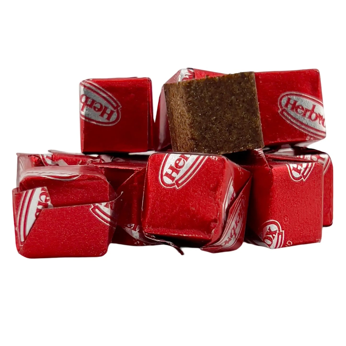 Stack of Herb-Ox chicken bouillon cubes wrapped in red foil, with one unwrapped cube placed on top.