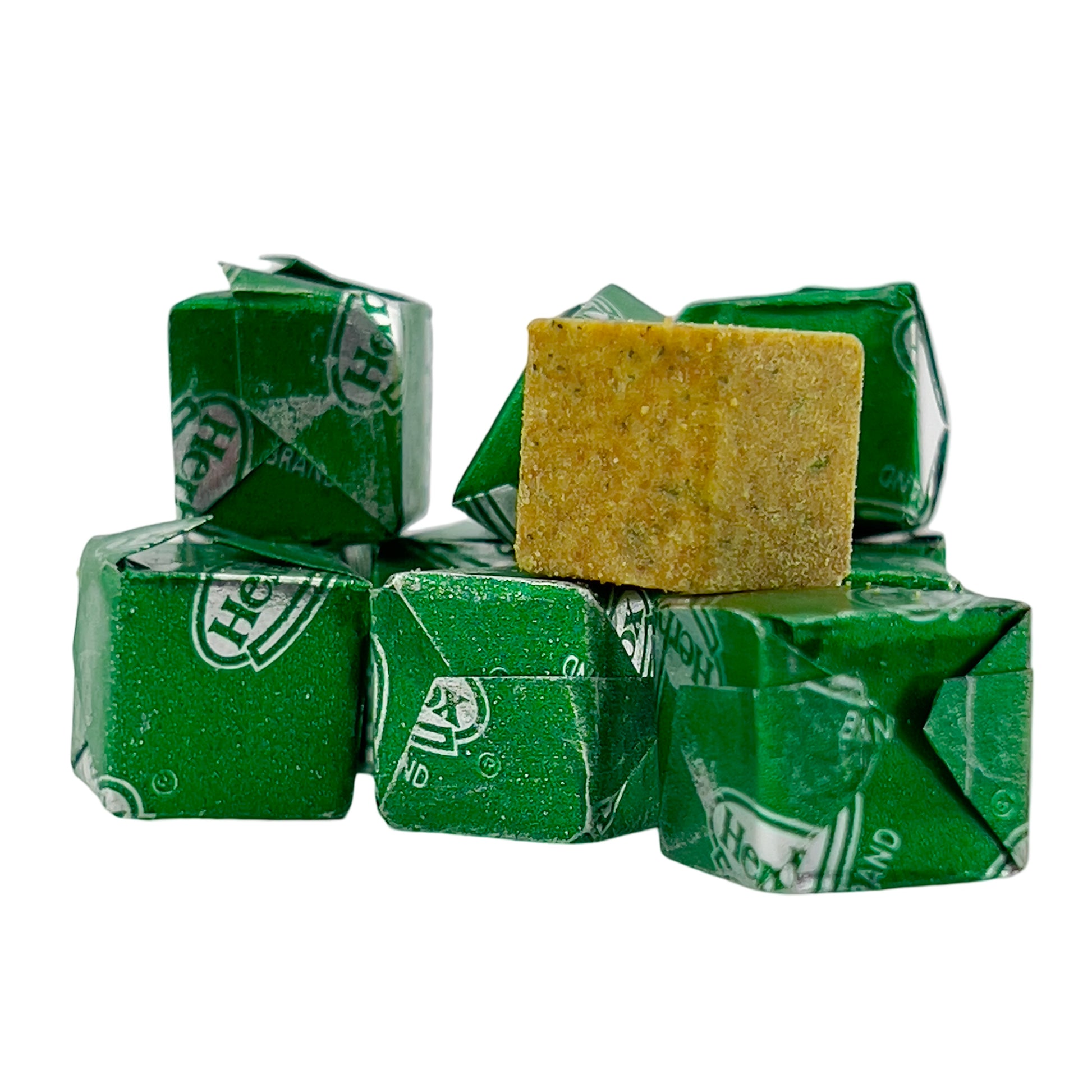 Herb-Ox chicken bouillon cubes with green wrapping, one cube unwrapped showing its texture.